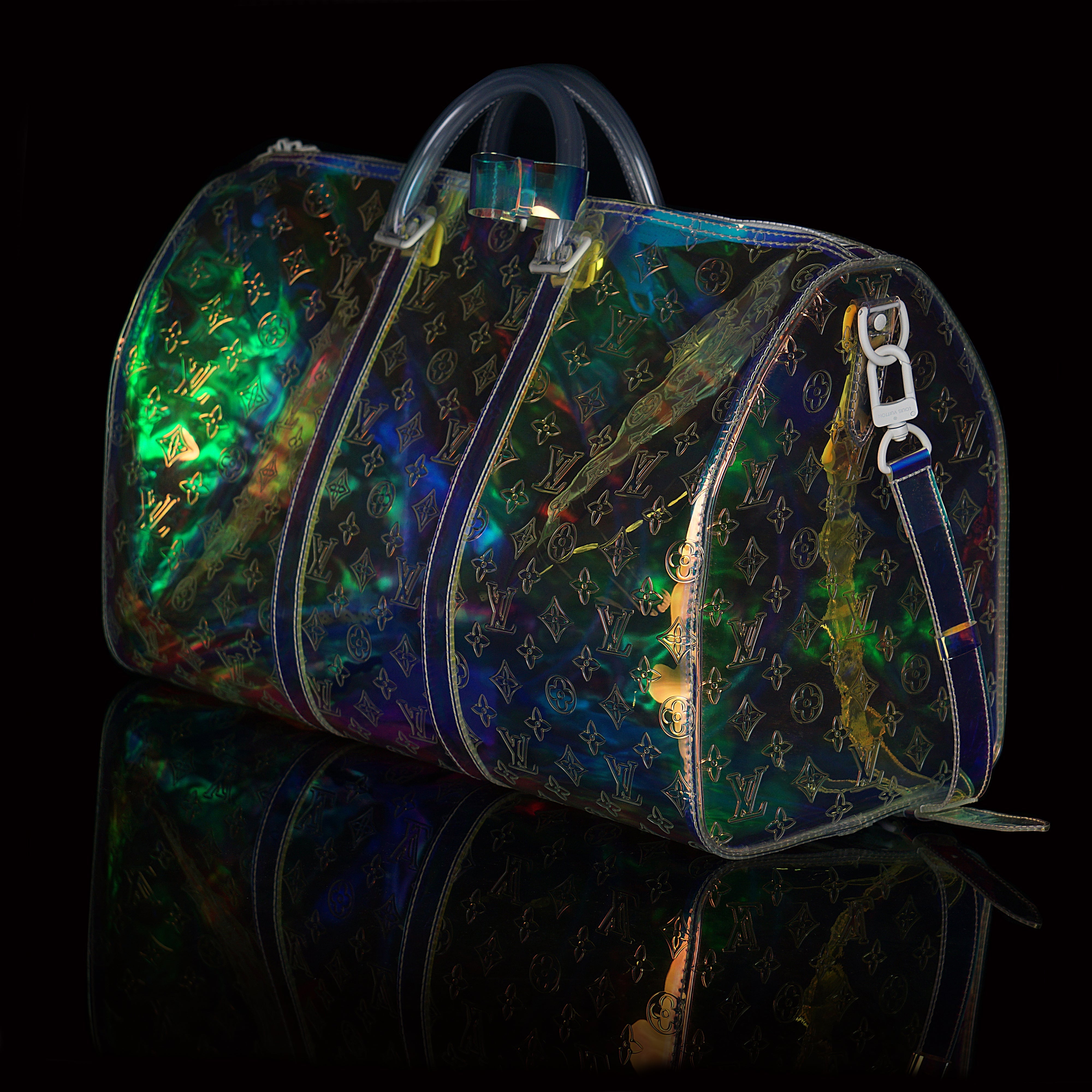 Louis Vuitton-Keepall-L 50 x H 22 x W 29 cm/L 19.7 x H 8.7 x W 11.4 inches Iridescent Prism Transparent embossed Monogram PVC PVC trim White detailing Top handle for hand or elbow carry Leather handle fastener Double zip closure Leather-covered padlock or