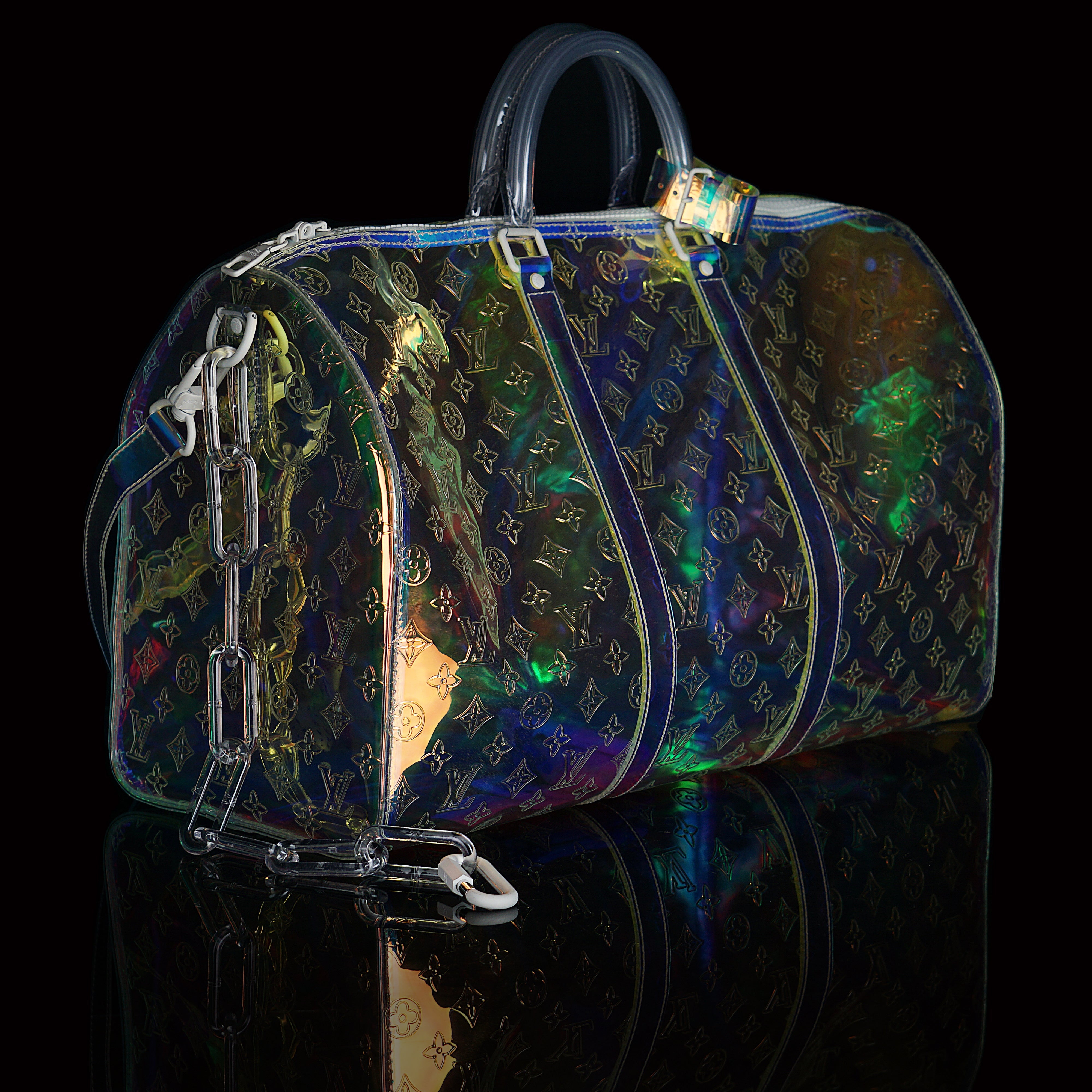 Louis Vuitton-Keepall-L 50 x H 22 x W 29 cm/L 19.7 x H 8.7 x W 11.4 inches Iridescent Prism Transparent embossed Monogram PVC PVC trim White detailing Top handle for hand or elbow carry Leather handle fastener Double zip closure Leather-covered padlock or