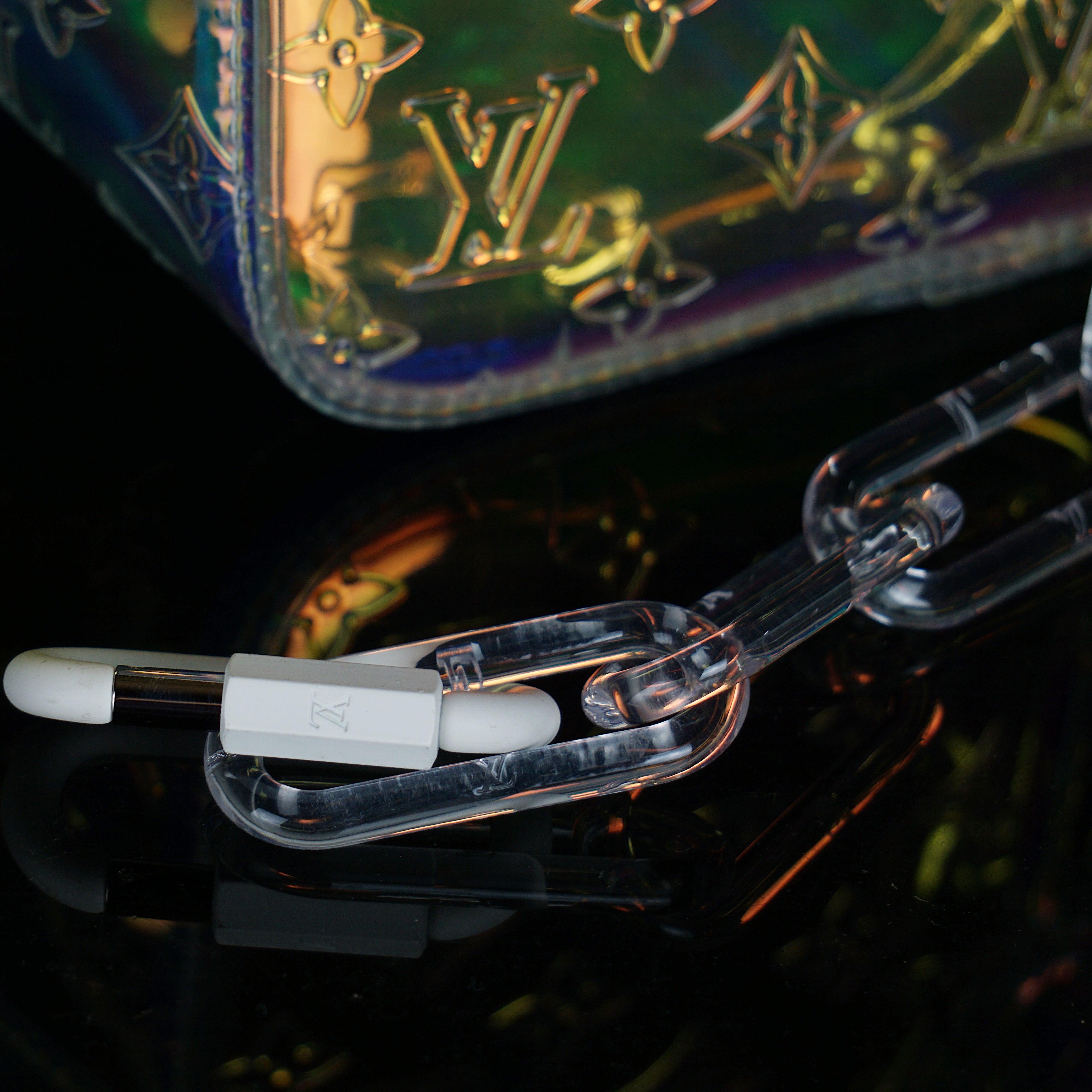 Louis Vuitton-Keepall-L 50 x H 22 x W 29 cm/L 19.7 x H 8.7 x W 11.4 inches Iridescent Prism Transparent embossed Monogram PVC PVC trim White detailing Top handle for hand or elbow carry Leather handle fastener Double zip closure Leather-covered padlock or