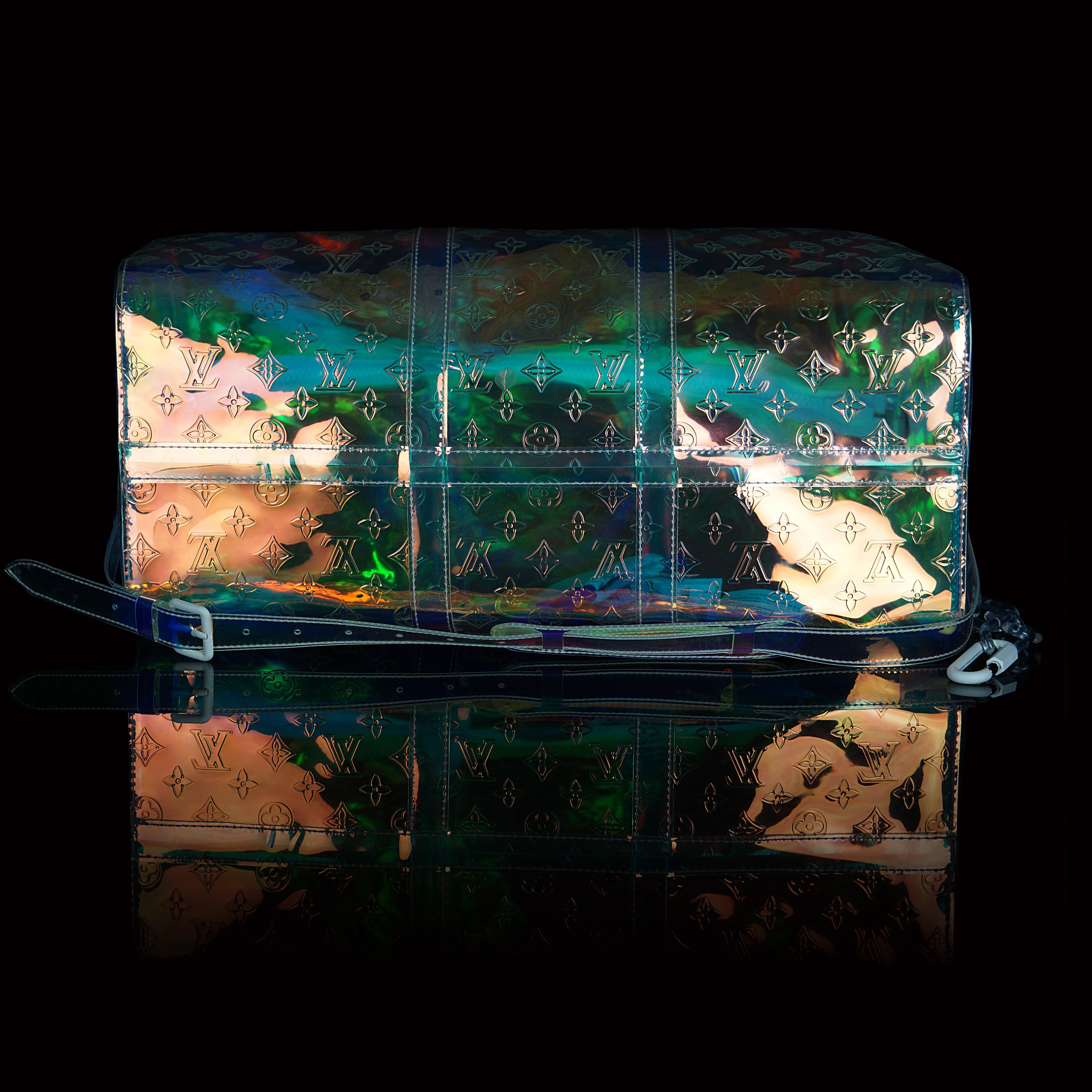 Louis Vuitton-Keepall-L 50 x H 22 x W 29 cm/L 19.7 x H 8.7 x W 11.4 inches Iridescent Prism Transparent embossed Monogram PVC PVC trim White detailing Top handle for hand or elbow carry Leather handle fastener Double zip closure Leather-covered padlock or