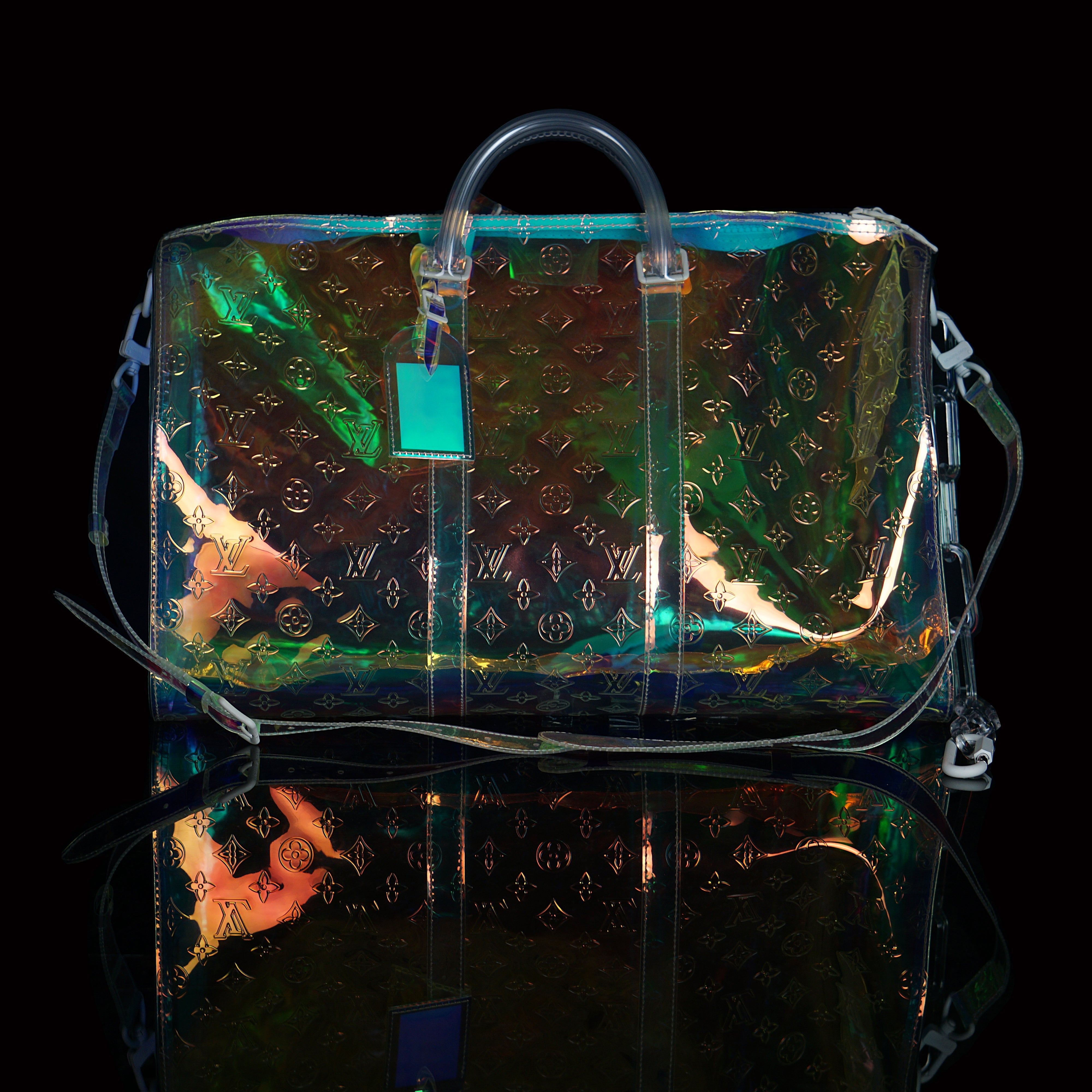 Louis Vuitton-Keepall-L 50 x H 22 x W 29 cm/L 19.7 x H 8.7 x W 11.4 inches Iridescent Prism Transparent embossed Monogram PVC PVC trim White detailing Top handle for hand or elbow carry Leather handle fastener Double zip closure Leather-covered padlock or