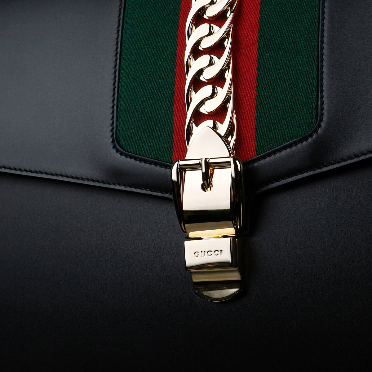Gucci-Sylvie Bag-Black leather Gucci Flag Gold toned hardware Interior zip and smartphone pockets Handle with 12cm drop Detachable shoulder strap with 41cm drop Nylon Web detail with metal chain and buckle closure Made in Italy-fabriqe.com
