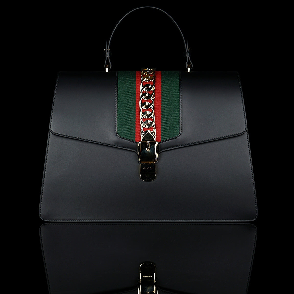 Gucci-Sylvie Bag-Black leather Gucci Flag Gold toned hardware Interior zip and smartphone pockets Handle with 12cm drop Detachable shoulder strap with 41cm drop Nylon Web detail with metal chain and buckle closure Made in Italy-fabriqe.com