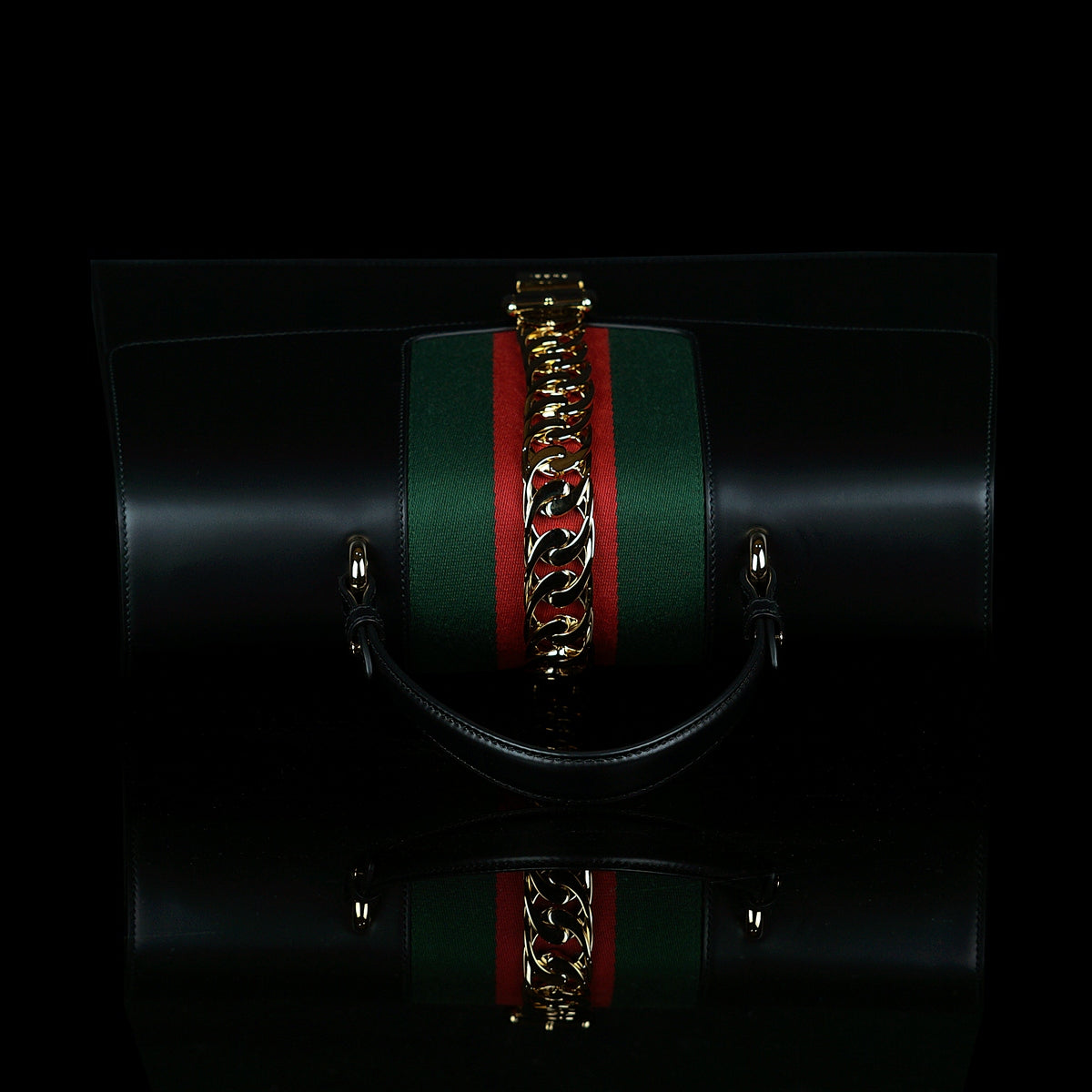 Gucci-Sylvie Bag-Black leather Gucci Flag Gold toned hardware Interior zip and smartphone pockets Handle with 12cm drop Detachable shoulder strap with 41cm drop Nylon Web detail with metal chain and buckle closure Made in Italy-fabriqe.com