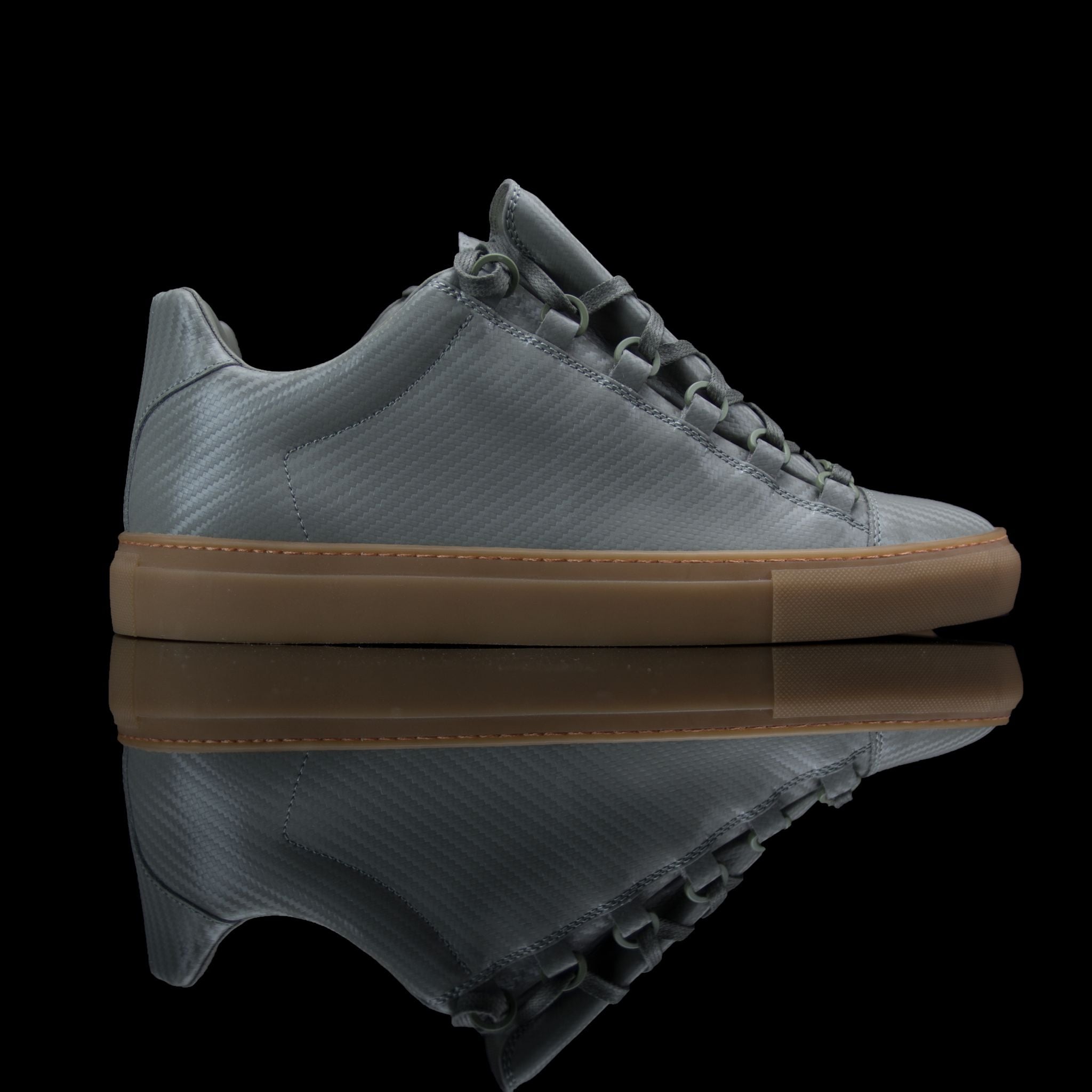 Balenciaga-Arena-Product Code: Colour: Khaki Carbon Fibre - Gum Sole Discontinued Material: Leather, Rubber Sole BALENCIAGA, the Paris based label drops the Arena Low. The casual sneakers are composed in Khaki Carbon Fibre Leather and Gum Sole. Also, the 
