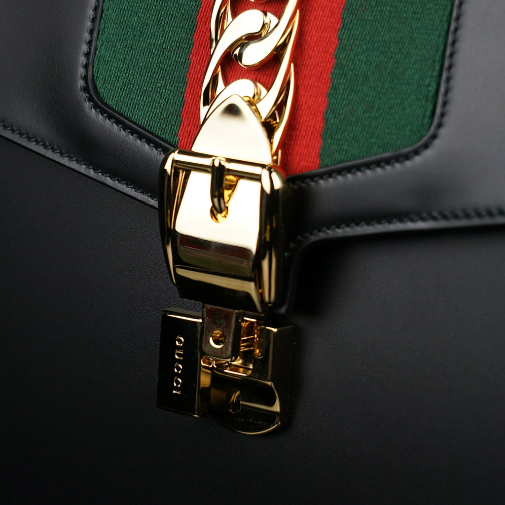 Gucci-Sylvie Bag-Black leather Gucci Flag Gold toned hardware Interior zip and smartphone pockets Handle with 12cm drop Detachable shoulder strap with 41cm drop Nylon Web detail with metal chain and buckle closure Made in Italy-fabriqe.com