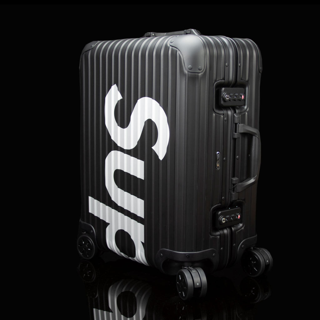 Rimowa-Suitcase-Colour: Black Exclusive-Limited Stock Aluminium/Aluminum, Plastic Handle Supreme X Rimowa Topas brings you the multiwheel suitcase. Designed exclusively for Supreme in aluminium bodies by Rimowa. Also, this suitcase feature TSA combination