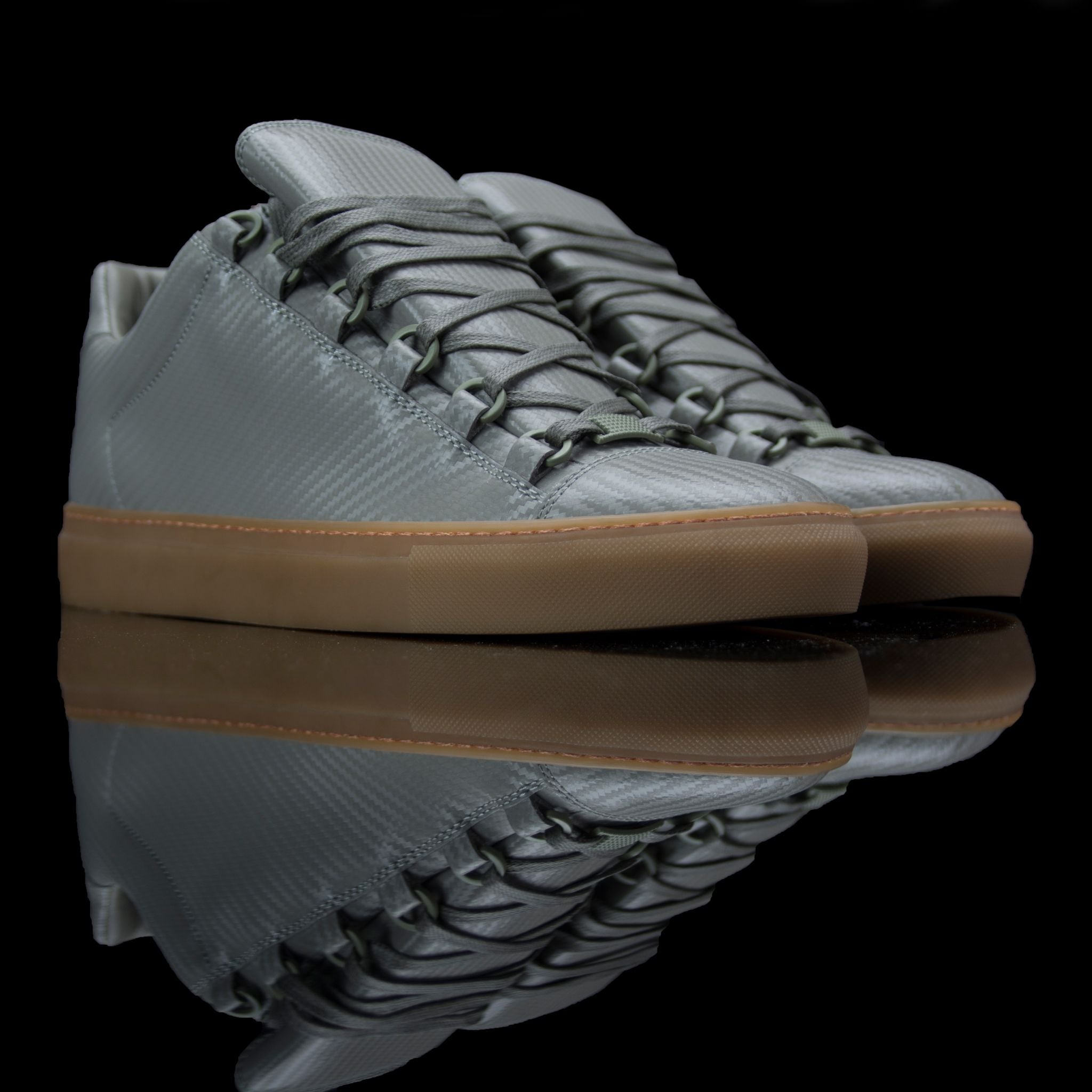 Balenciaga-Arena-Product Code: Colour: Khaki Carbon Fibre - Gum Sole Discontinued Material: Leather, Rubber Sole BALENCIAGA, the Paris based label drops the Arena Low. The casual sneakers are composed in Khaki Carbon Fibre Leather and Gum Sole. Also, the 